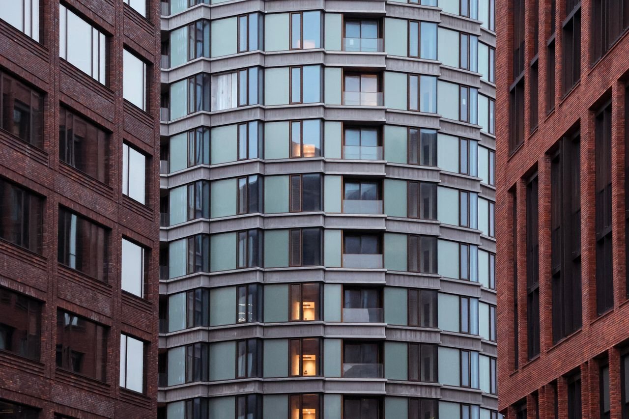 View of modern architectural buildings with glass and brick facades in Copenhagen, Denmark.