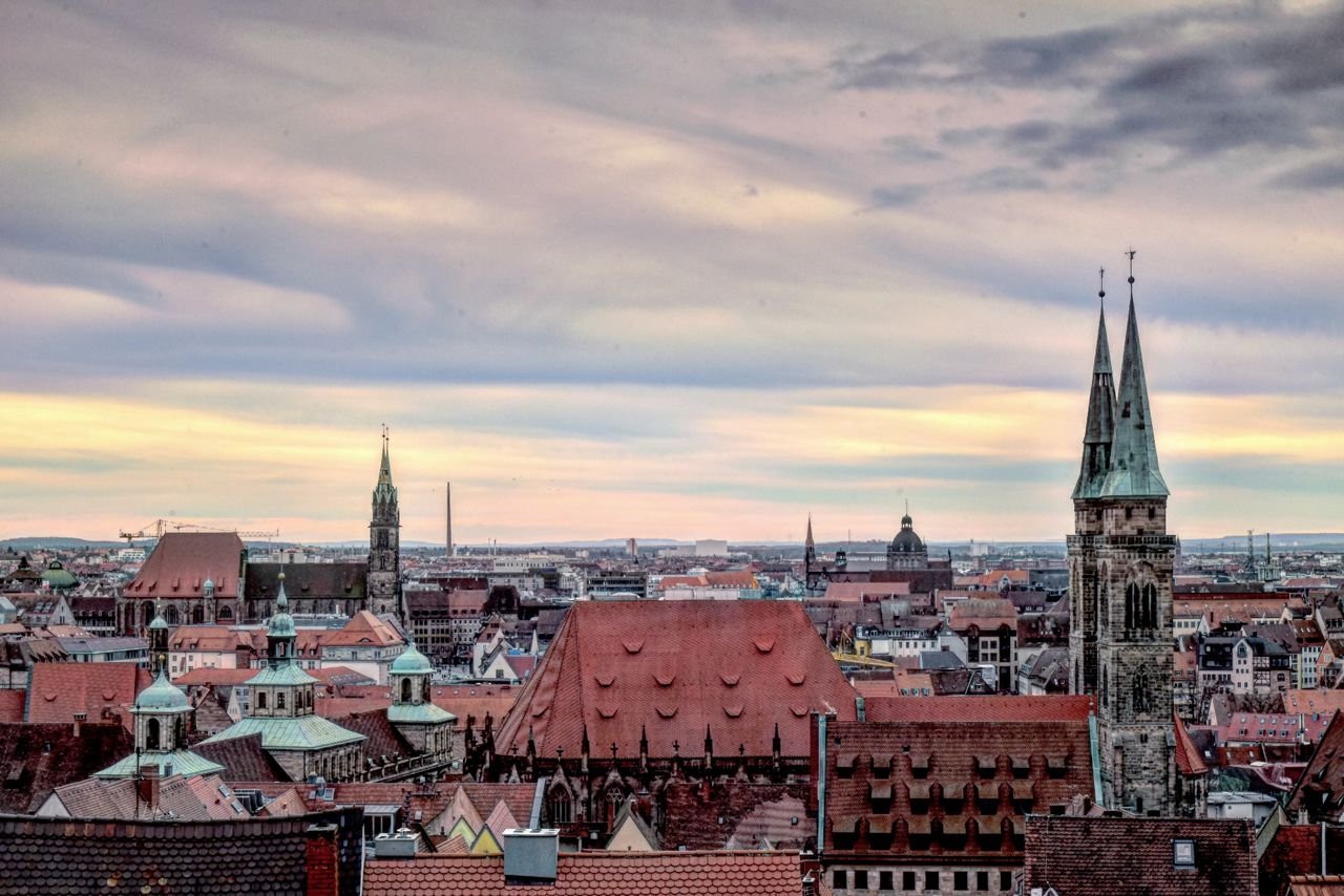Fully Funded Scholarships in Germany for International Students 2027 A stunning view of Nuremberg's historic skyline with iconic church towers and a vibrant sky.